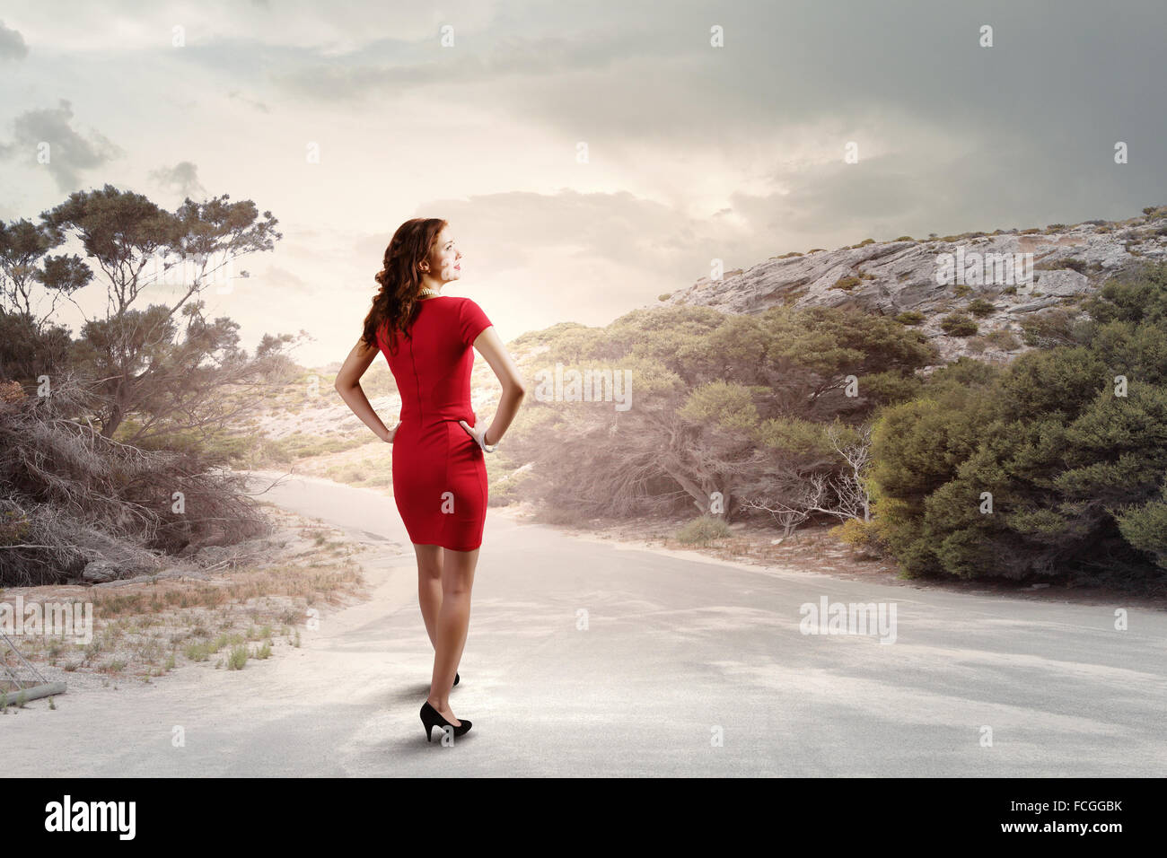 Rear view of young woman standing aside of road Stock Photo - Alamy