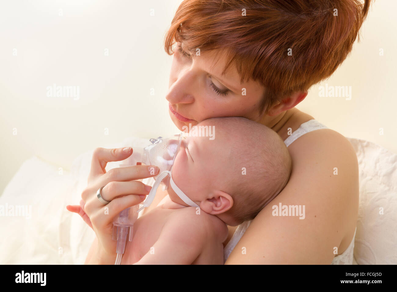 Sick baby of 7 weeks old getting treatment with nebuliser or aerosol Stock Photo