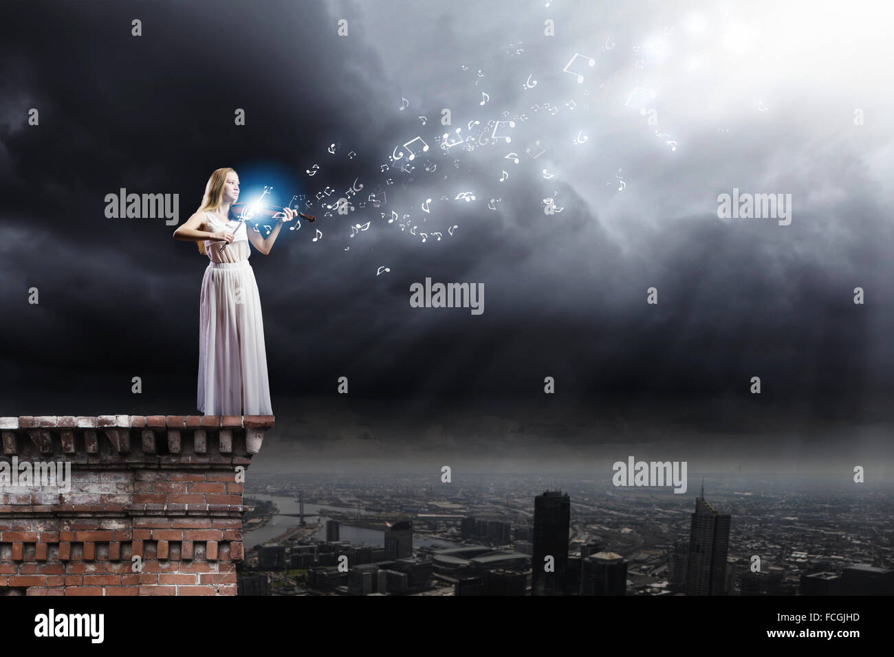 Young woman in white dress playing violin at night Stock Photo - Alamy