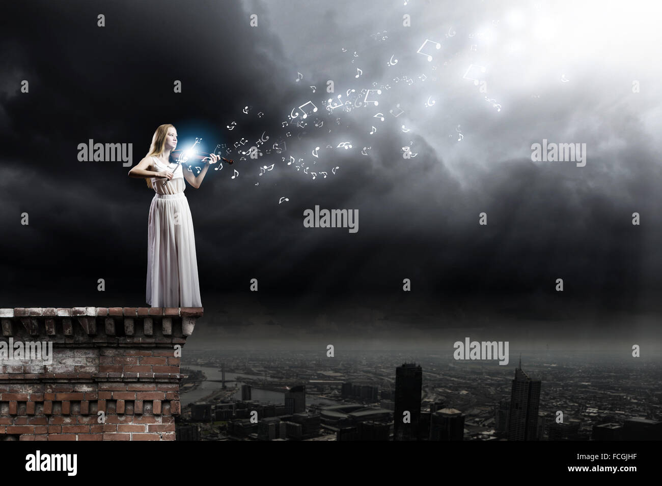 Young woman in white dress playing violin at night Stock Photo - Alamy