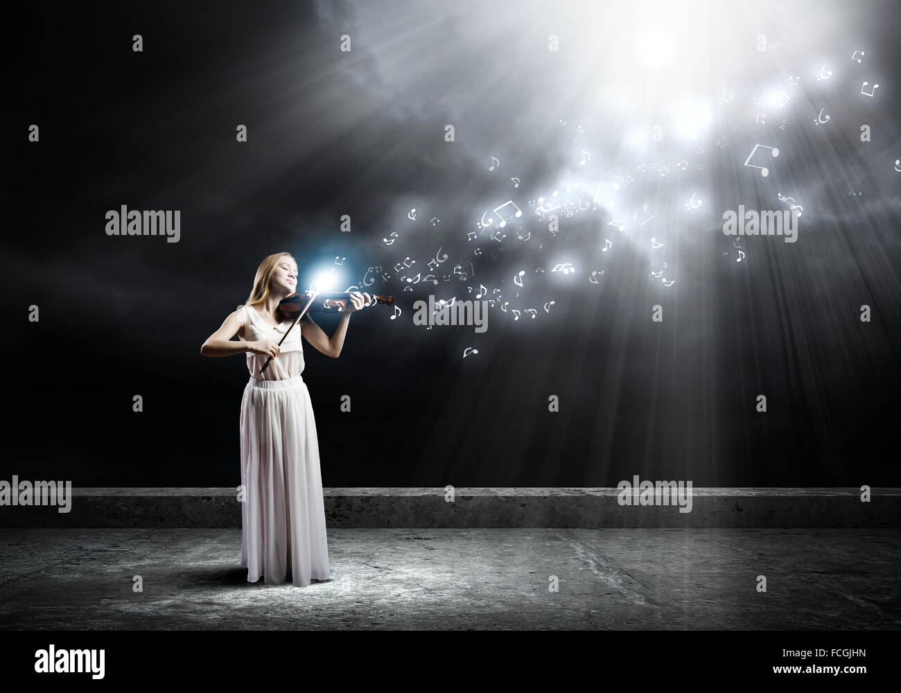 Young woman in white dress playing violin at night Stock Photo - Alamy