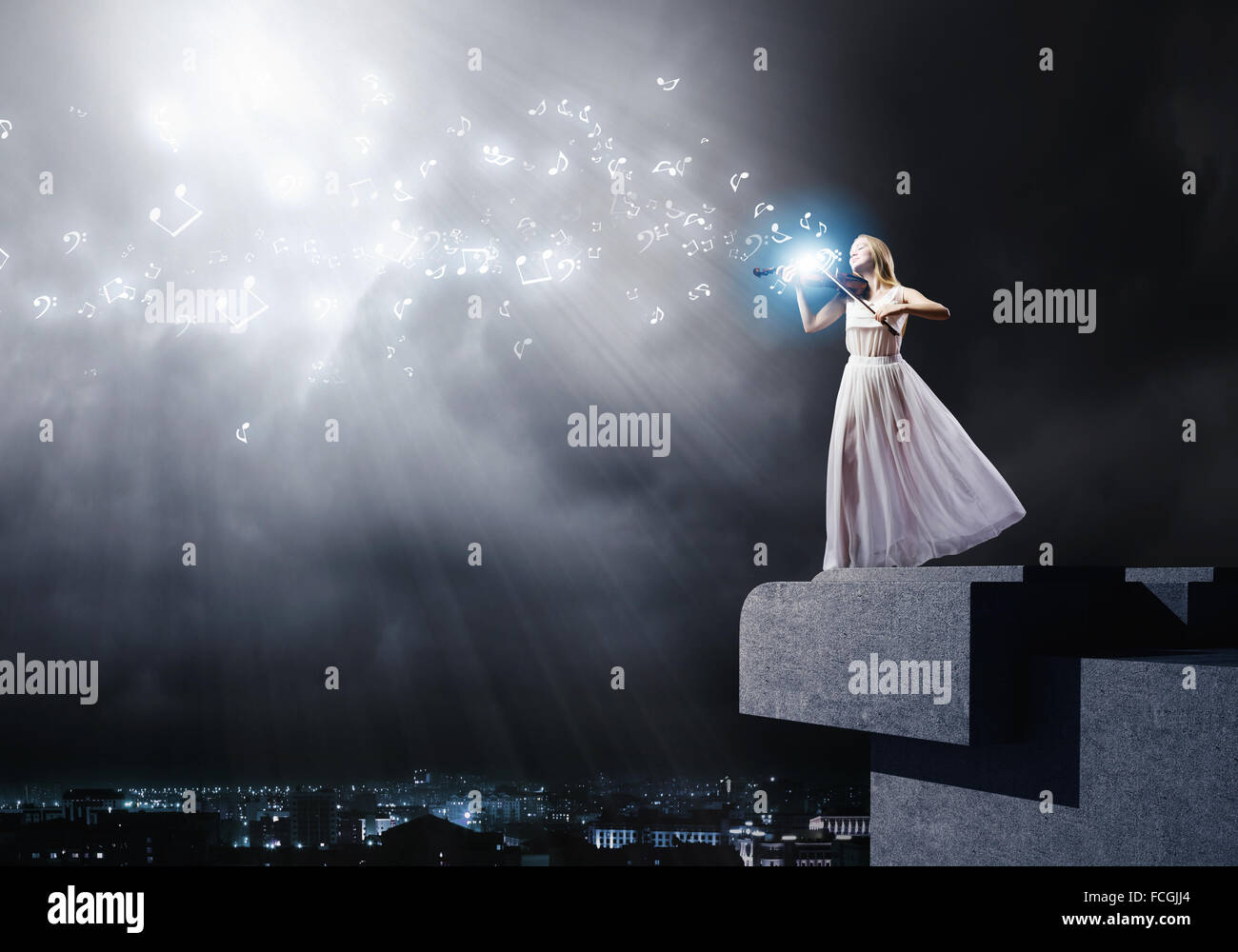 Young woman in white dress playing violin at night Stock Photo - Alamy
