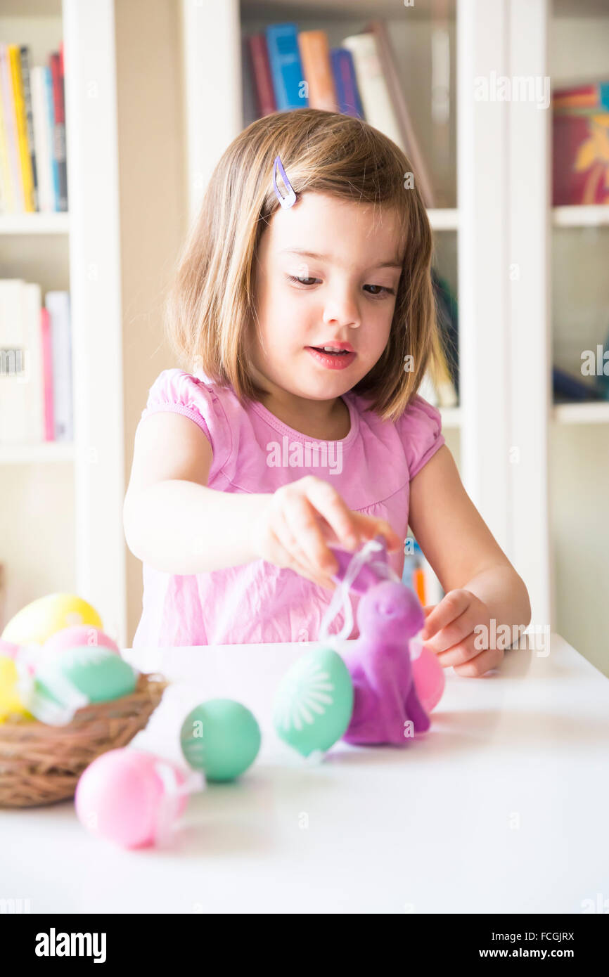 Little girl playing Easter eggs and Easter bunny Stock Photo Alamy