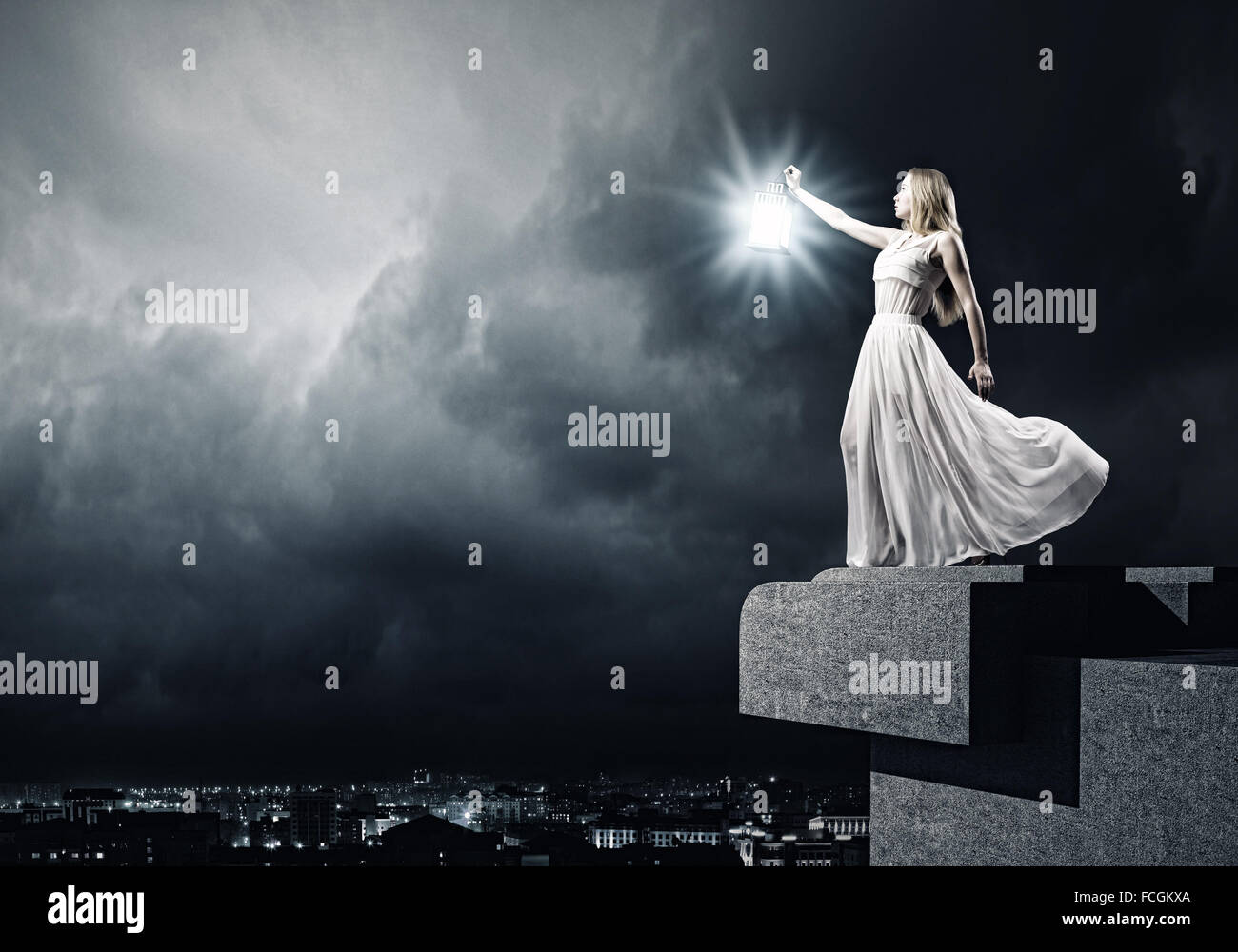 Young woman in white long dress with lantern Stock Photo - Alamy
