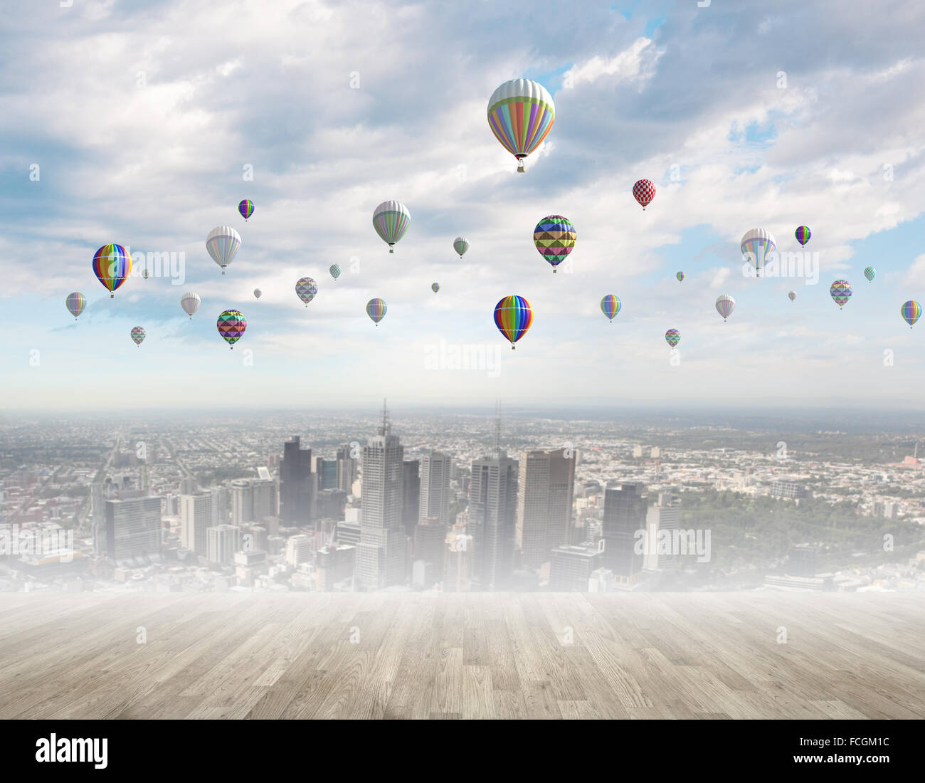 Colorful aerostats flying in clear sky above modern city Stock Photo ...