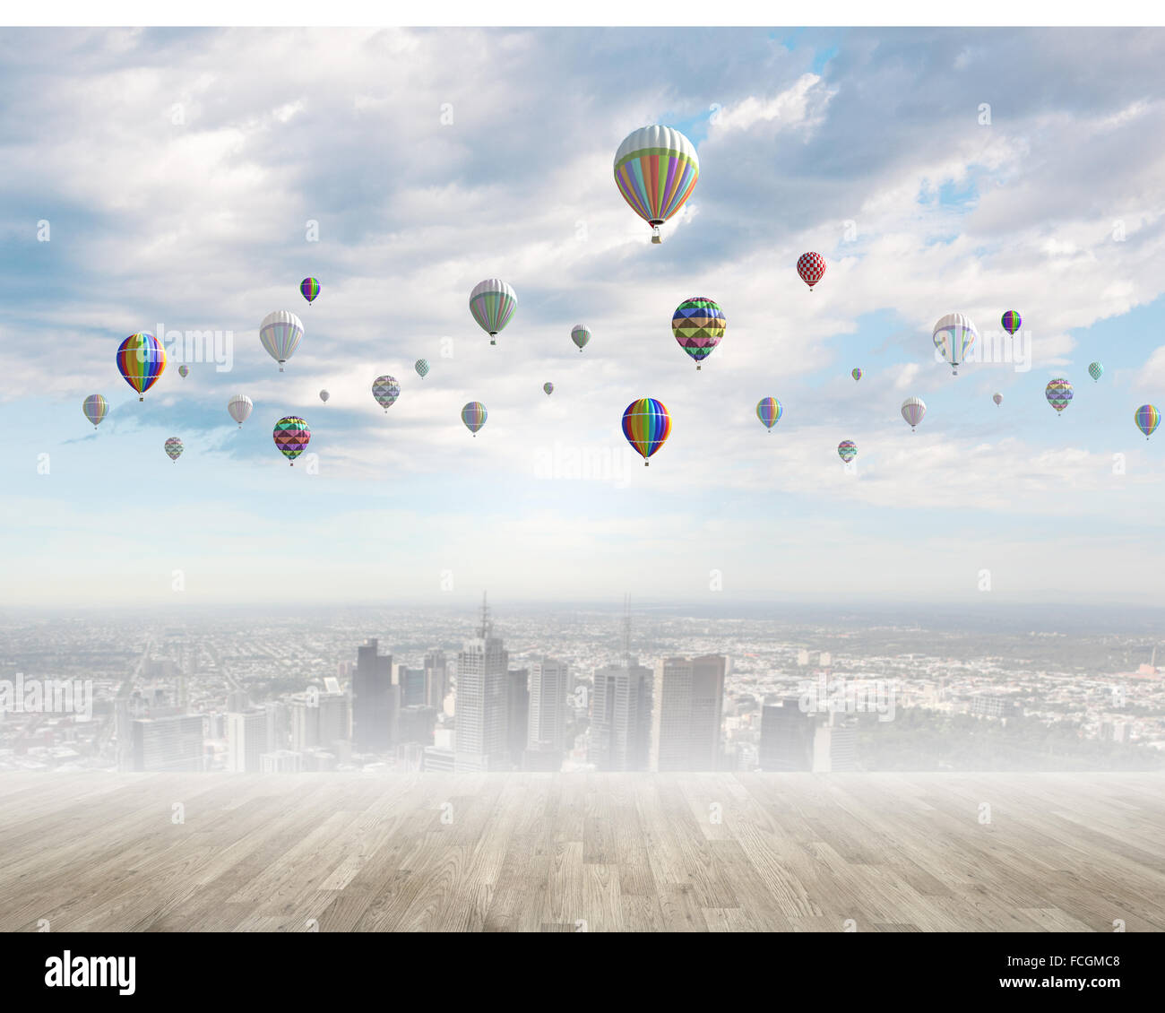 Colorful aerostats flying in clear sky above modern city Stock Photo ...