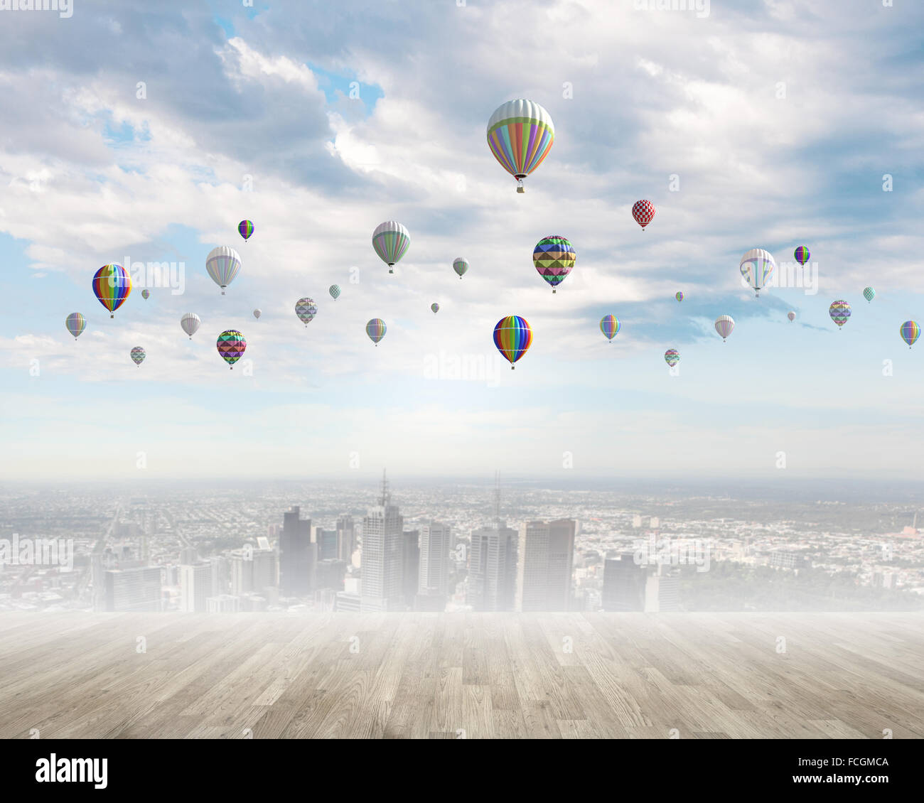 Colorful aerostats flying in clear sky above modern city Stock Photo ...