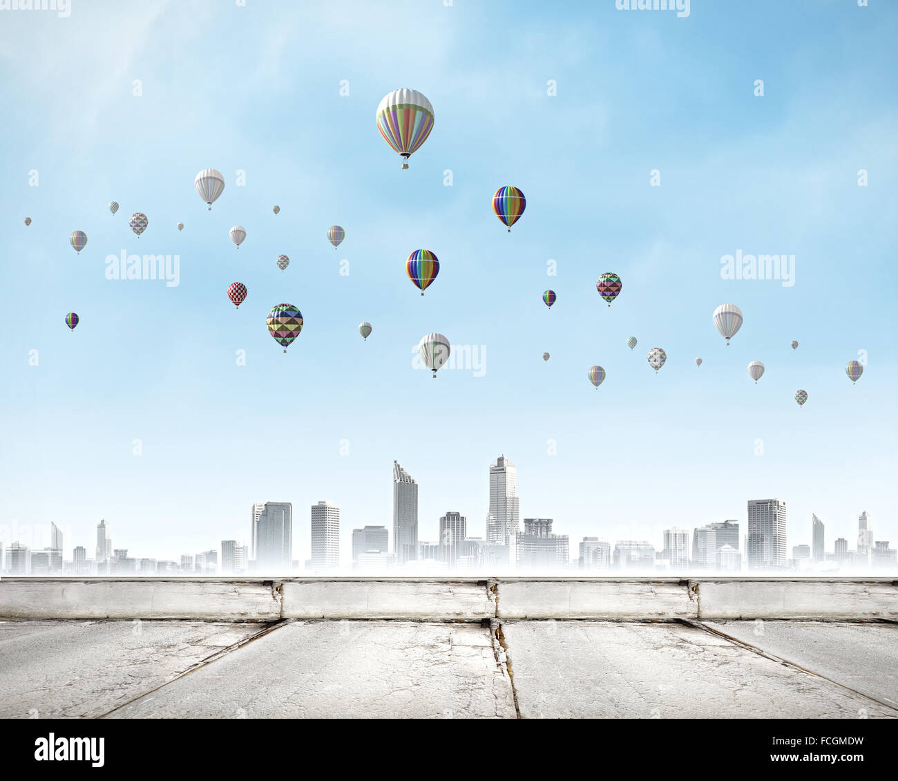 Colorful aerostats flying in clear sky above modern city Stock Photo ...