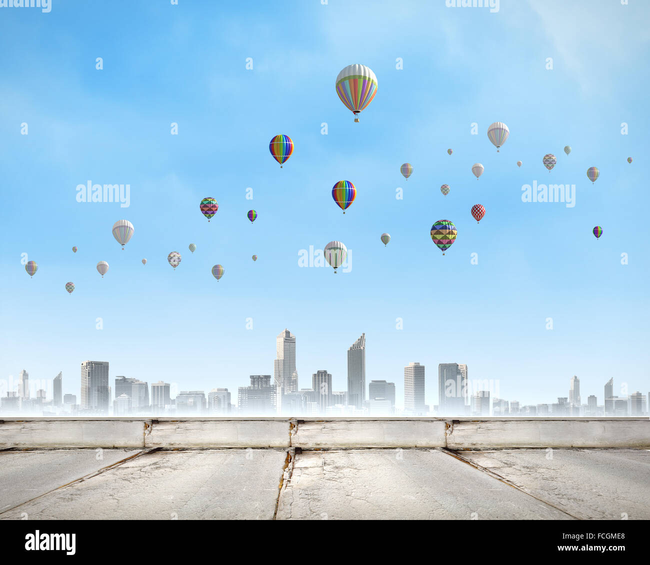 Colorful aerostats flying in clear sky above modern city Stock Photo ...