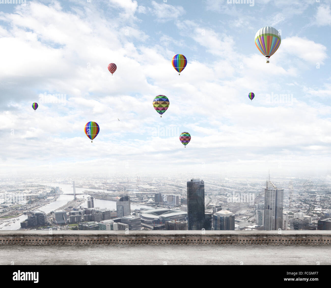 Colorful aerostats flying in clear sky above modern city Stock Photo ...
