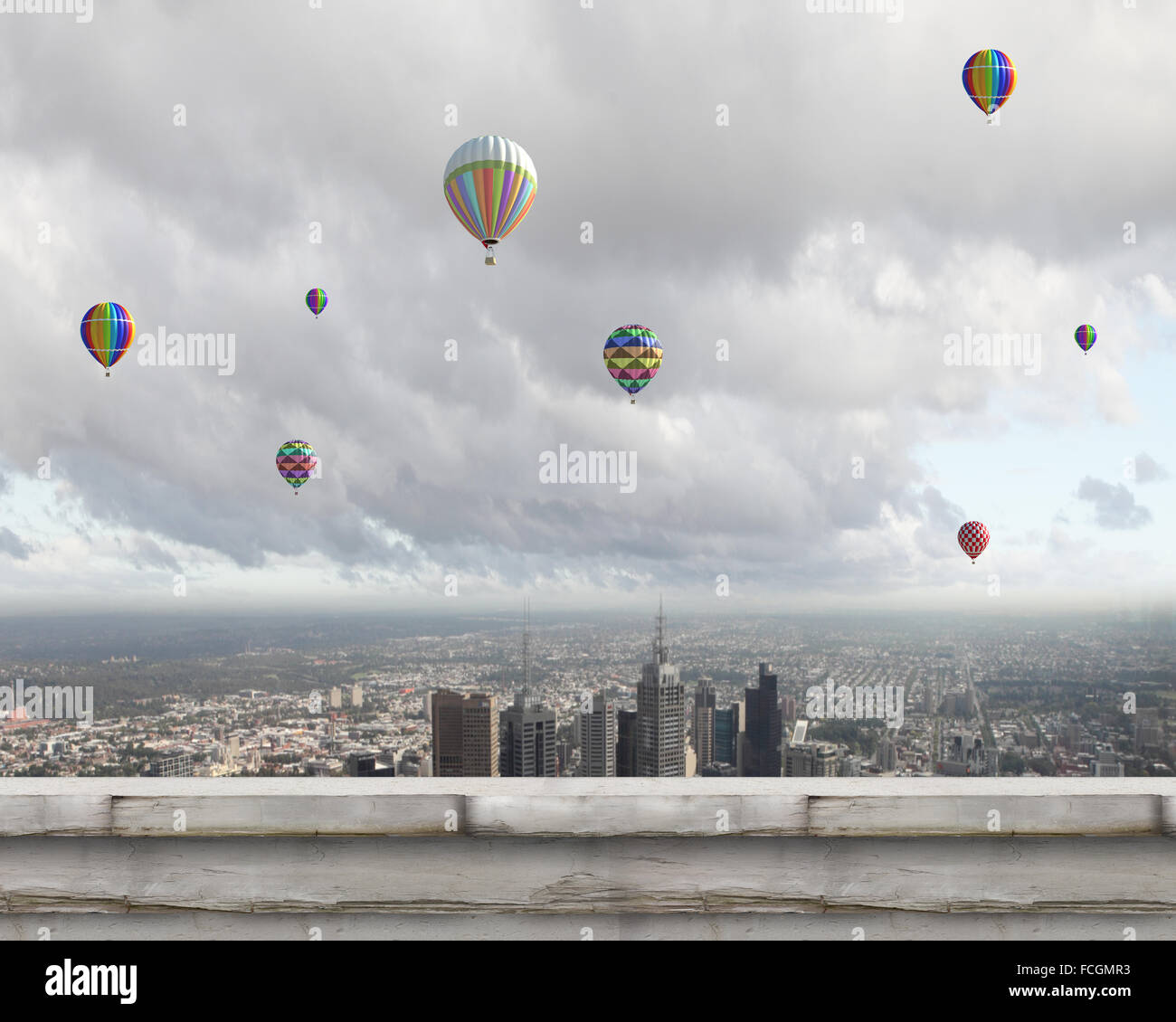 Colorful aerostats flying in clear sky above modern city Stock Photo ...