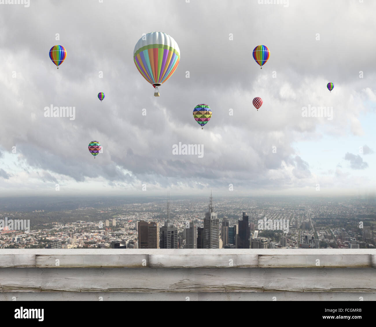 Colorful aerostats flying in clear sky above modern city Stock Photo ...