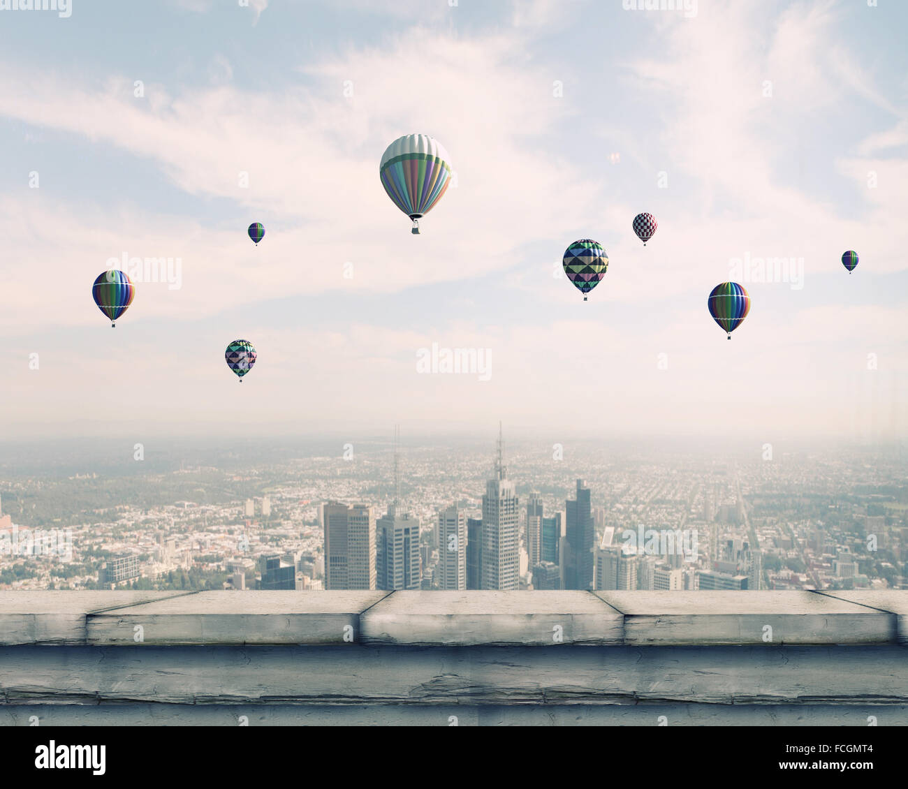 Colorful aerostats flying in clear sky above modern city Stock Photo ...