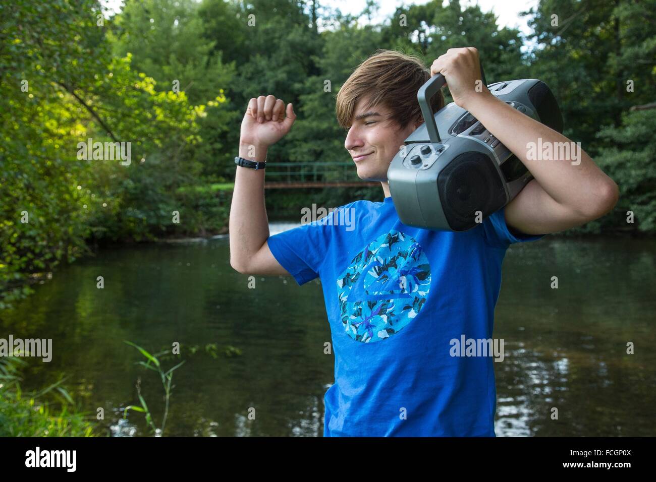 TEENAGER AND MUSIC IN NATURE Stock Photo