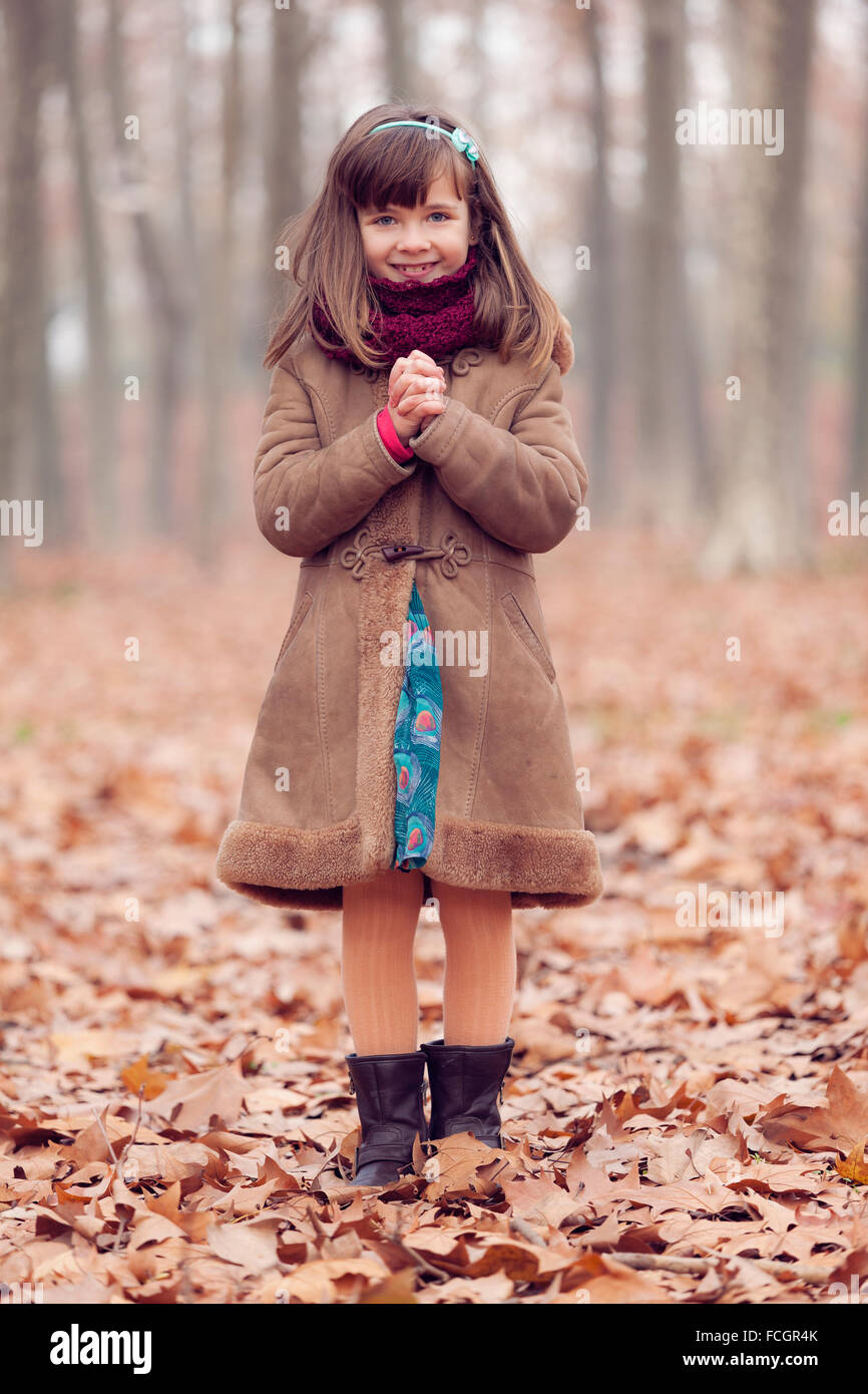 Young girl brown coat in park autum smiling hands folded Stock Photo ...