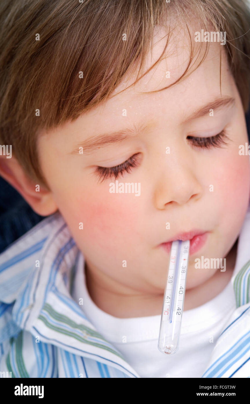 Portrait of little boy clinical thermometer in his mouth Stock