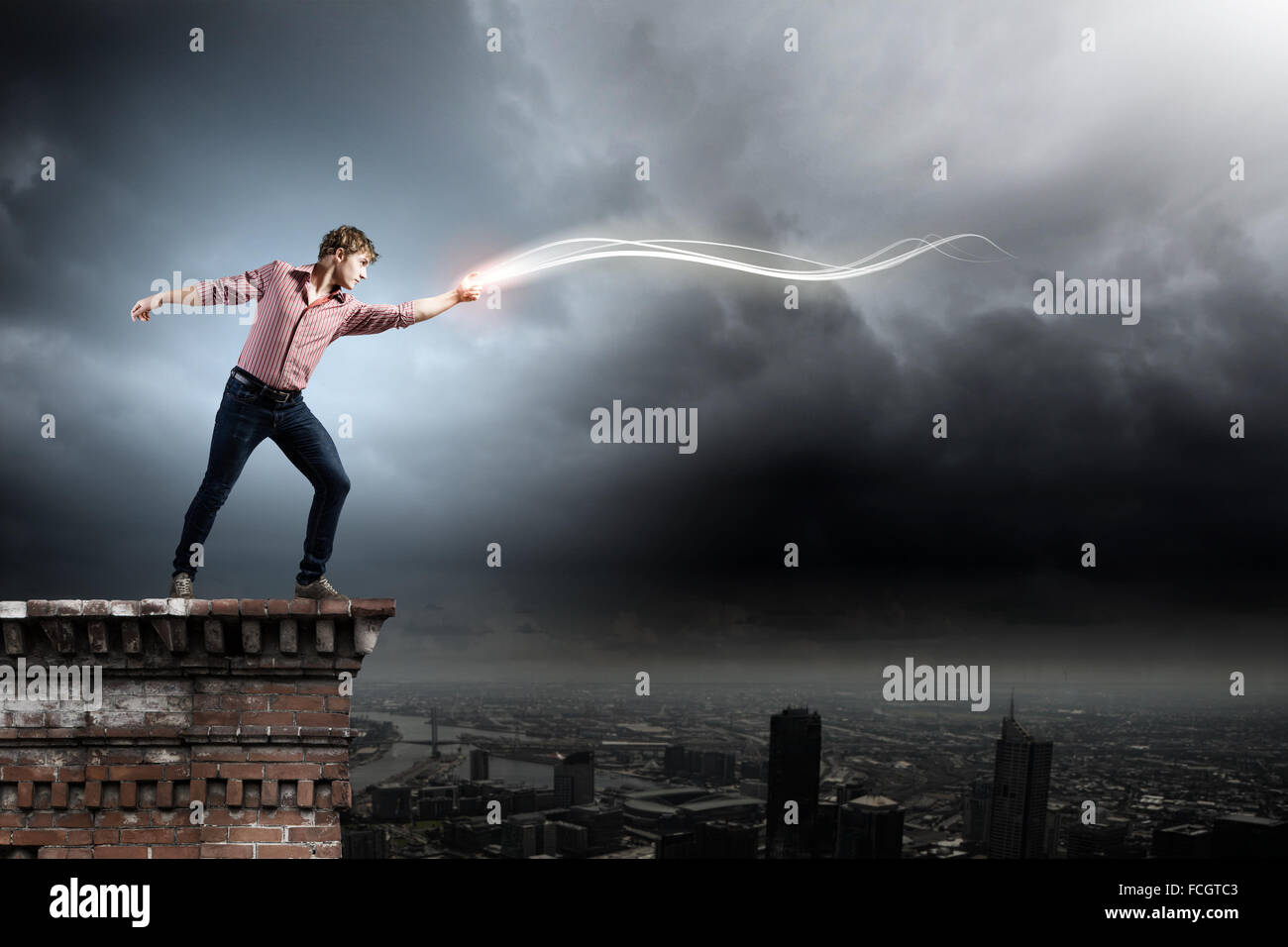 Throwing Look Effect Young man in casual throwing light splashes Stock Photo - Alamy