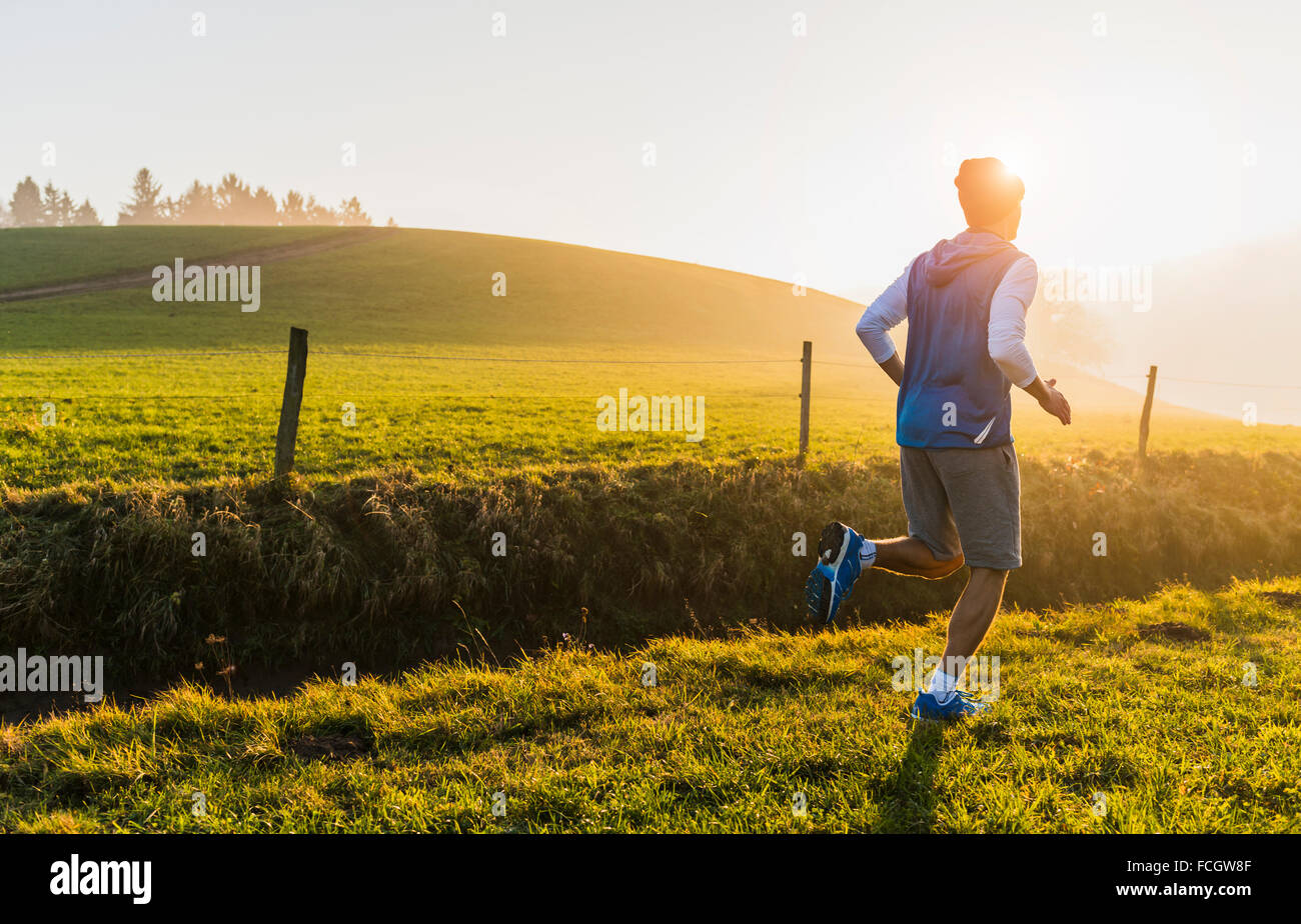 Young man jogging in the morning Stock Photo