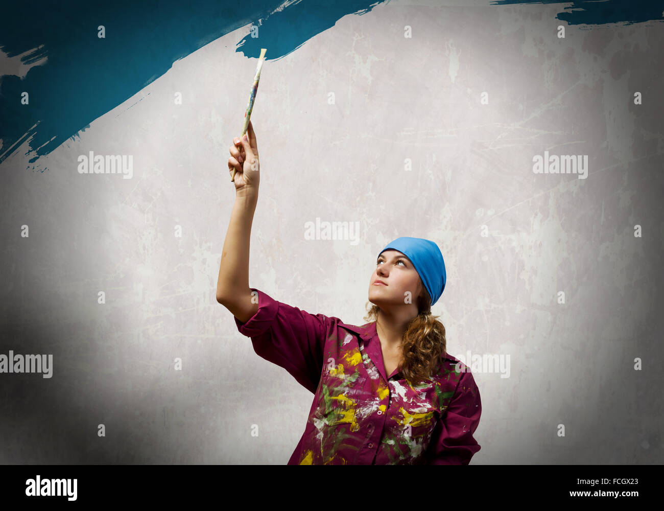 Young woman painting wall in colors with brush Stock Photo - Alamy