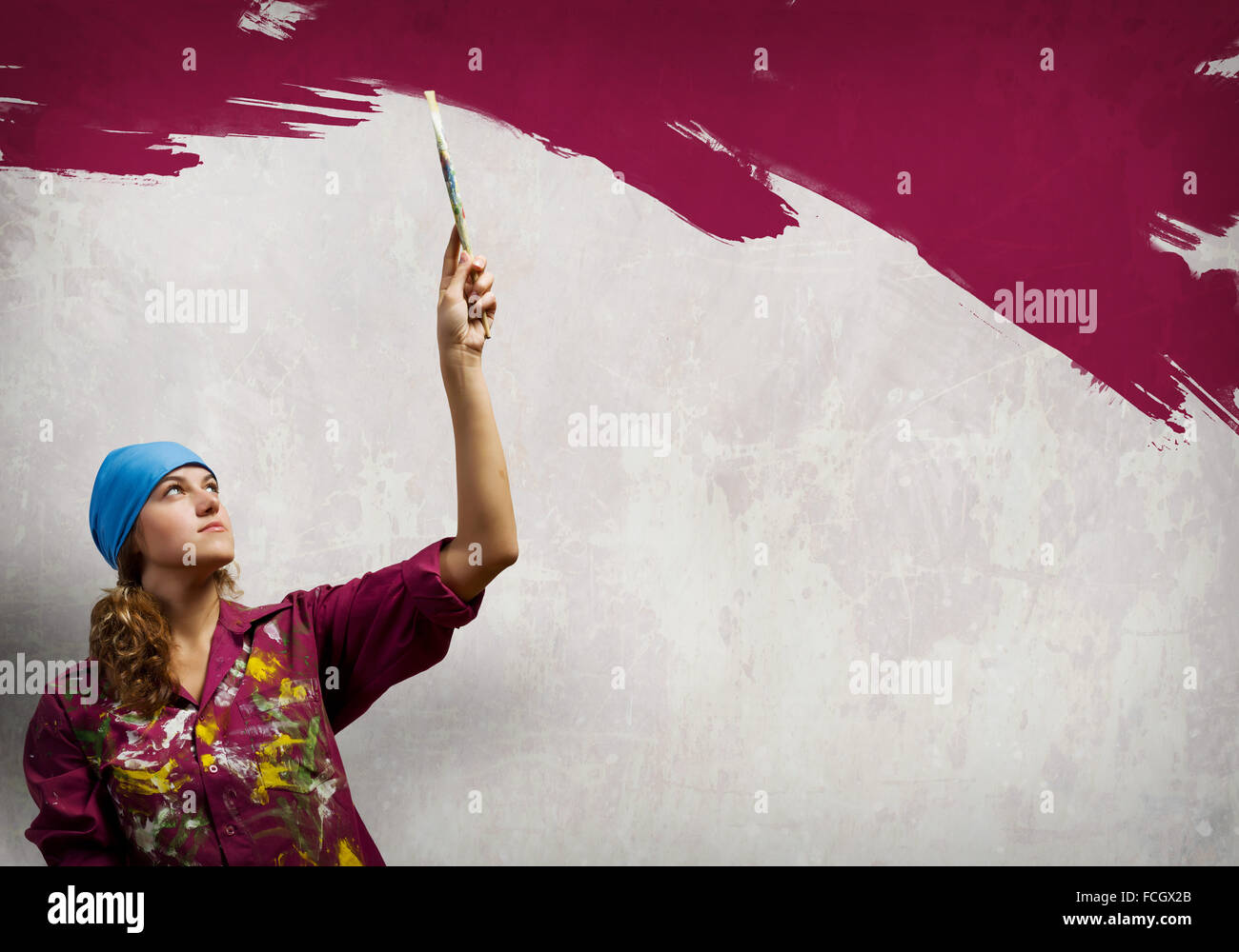 Young woman painting wall in colors with brush Stock Photo - Alamy