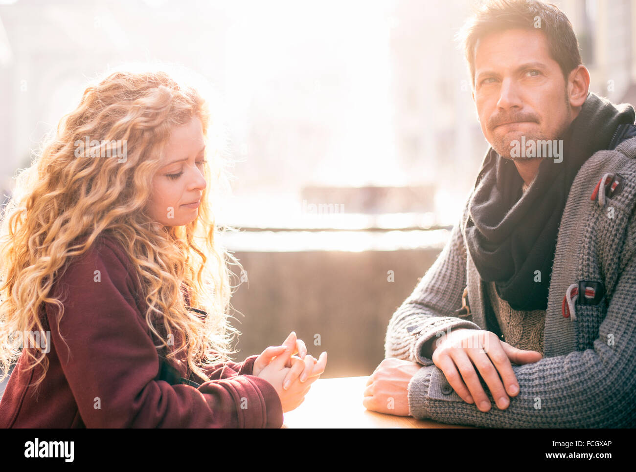 Displeased couple sitting together at a table Stock Photo