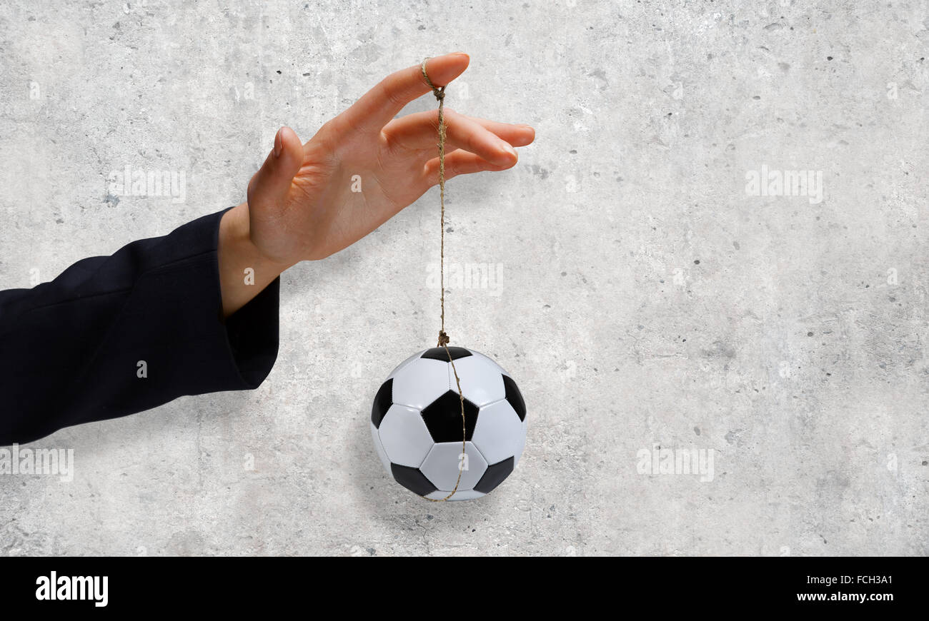 Close up of businessman hand and ball hanging on rope Stock Photo - Alamy