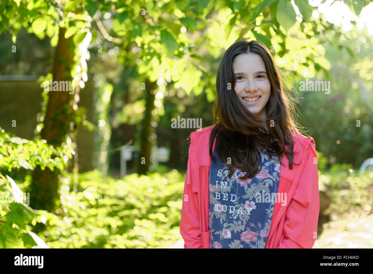 Portrait of smiling teenage girl in nature Stock Photo - Alamy