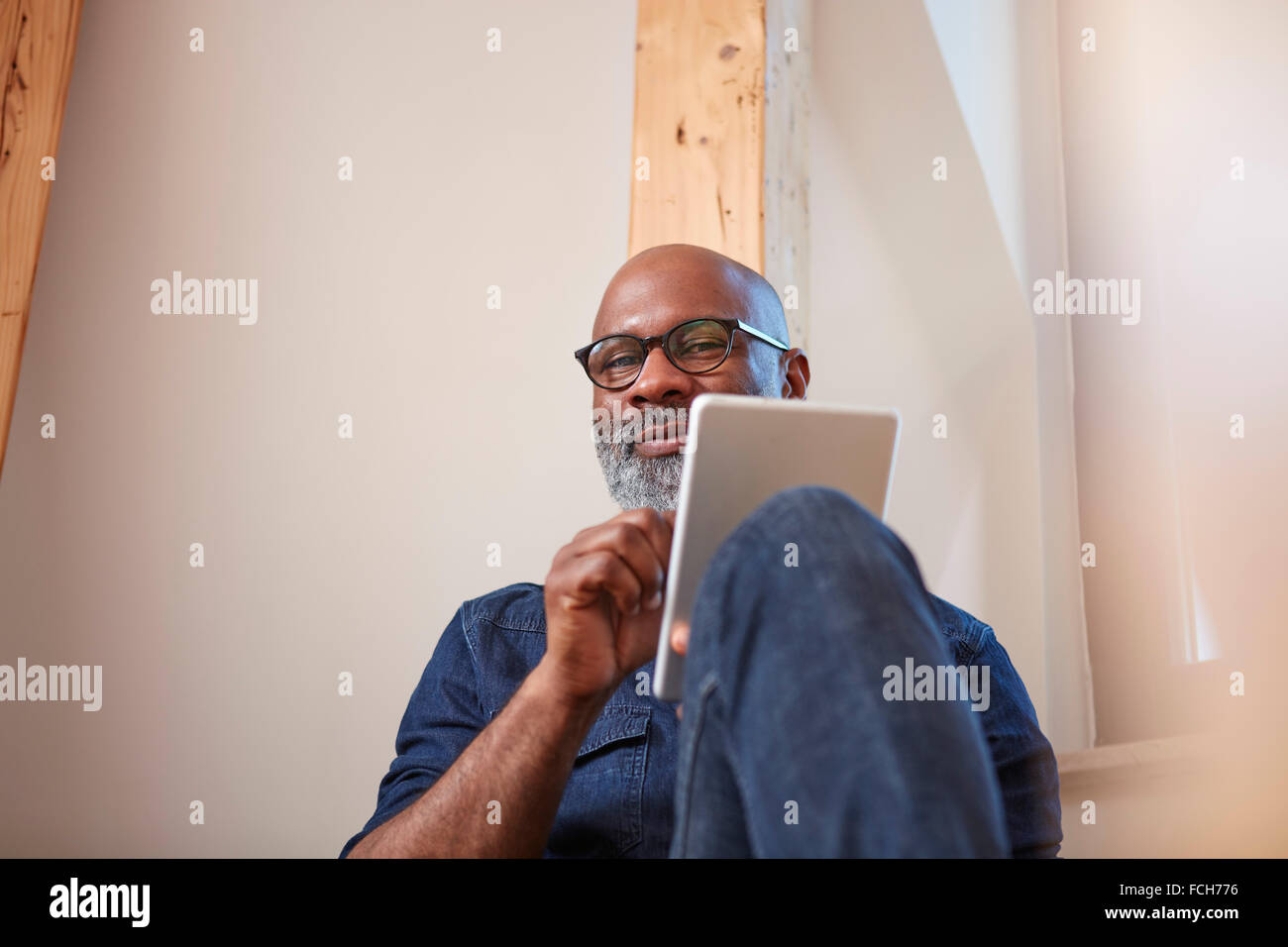 Portrait of smiling man   digital tablet Stock Photo