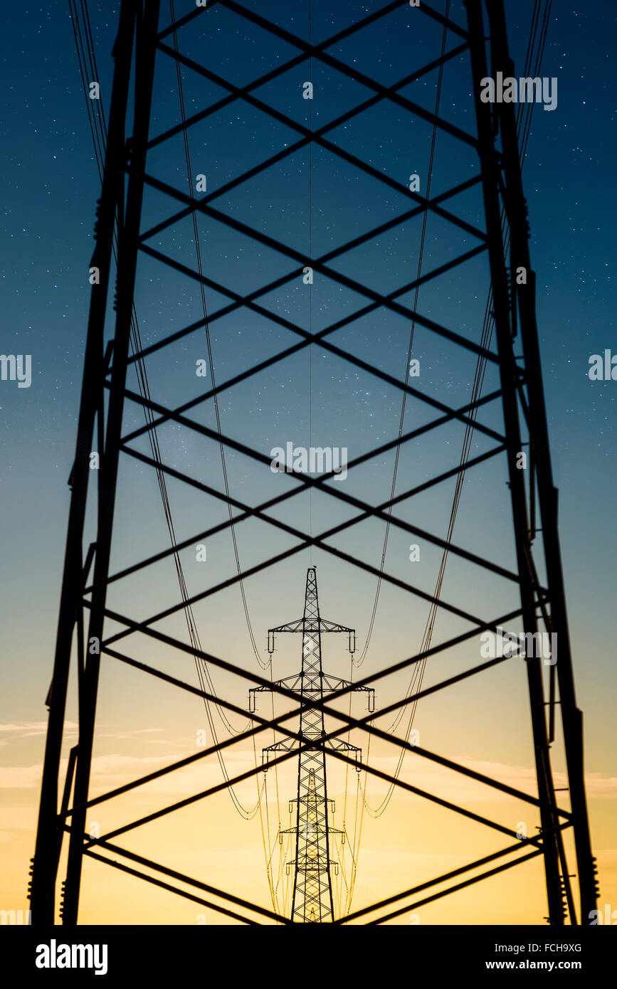 Austria Braunau am Inn District power pylons in the evening Stock Photo