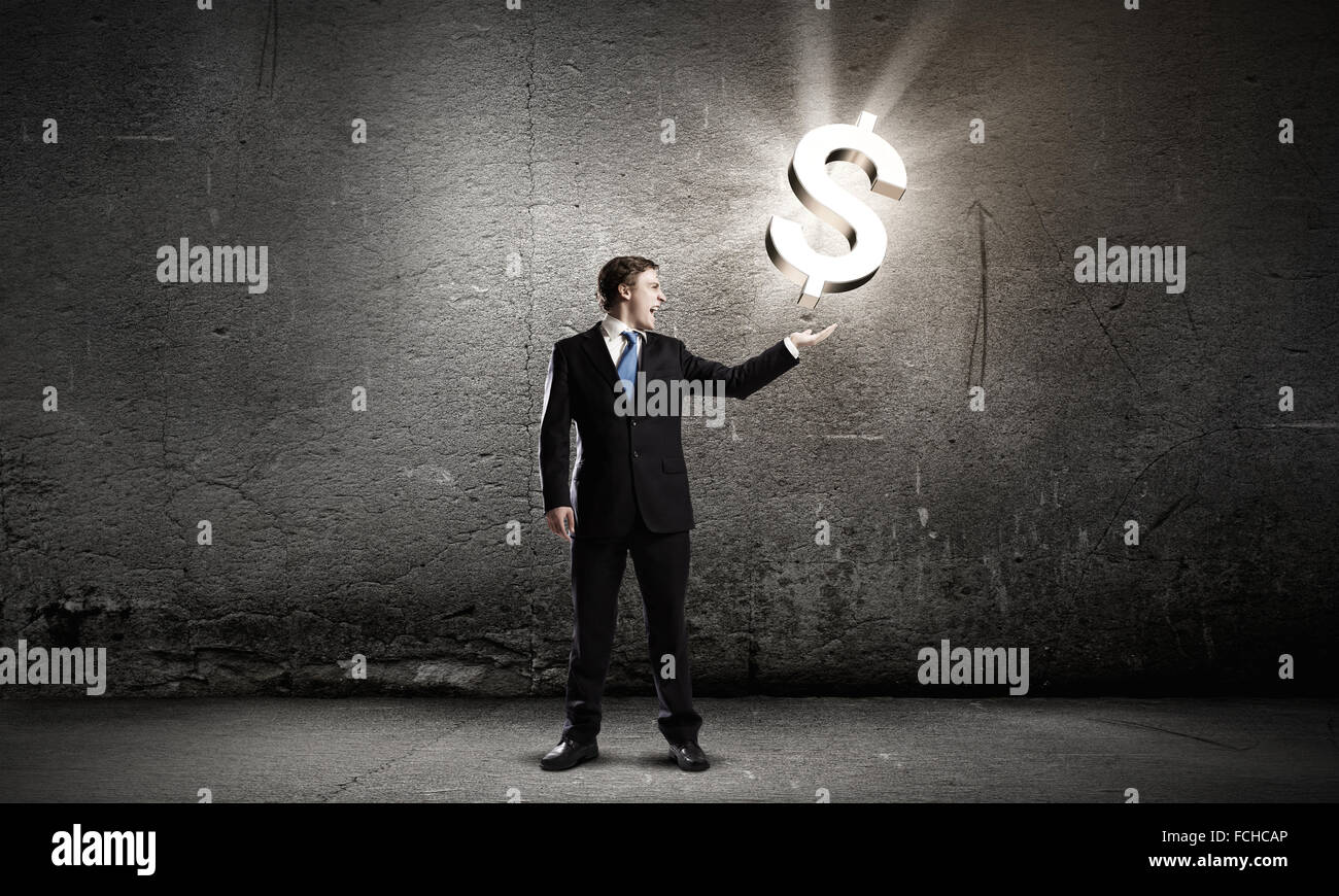 Businessman in suit holding dollar sign in palm Stock Photo - Alamy