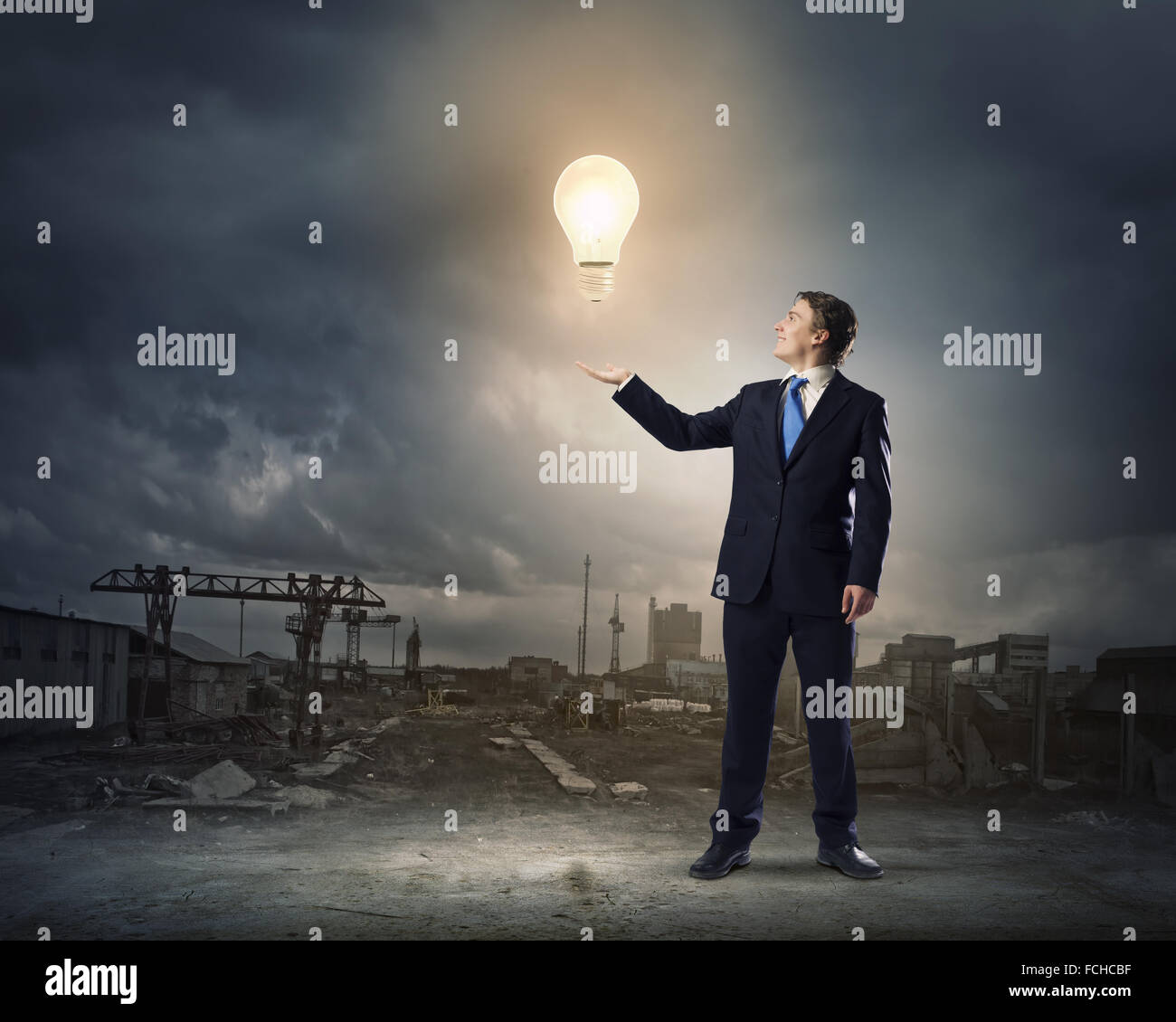 Young businessman holding light bulb in palm Stock Photo - Alamy