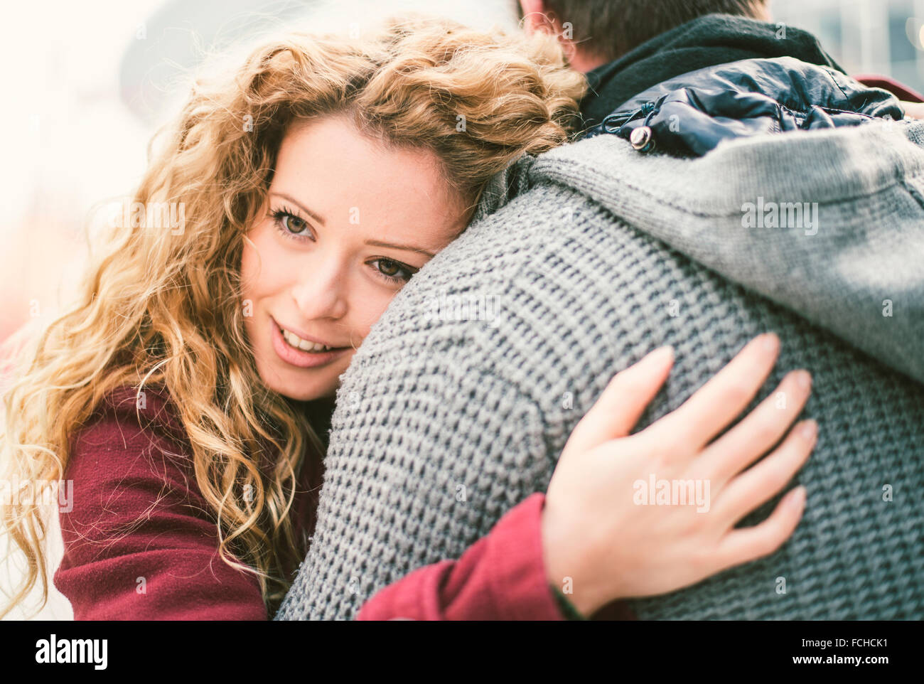 Portrait of smiling young woman hugging her boyfriend Stock Photo - Alamy