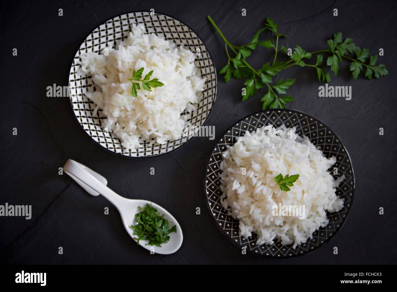 Parli Rice Two bowls of long grain rice parsley Stock Photo - Alamy