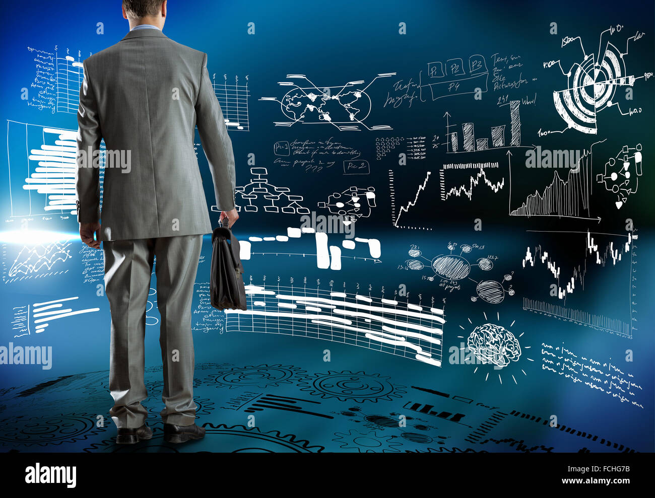 Rear view of businessman and business strategy sketches on wall Stock ...