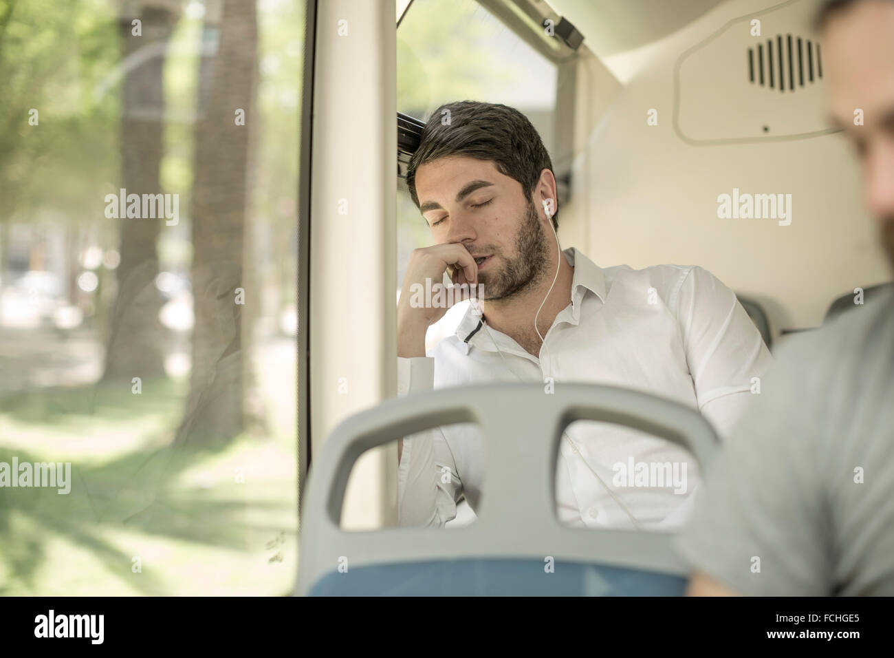 Young man sleeping in city bus Stock Photo Alamy