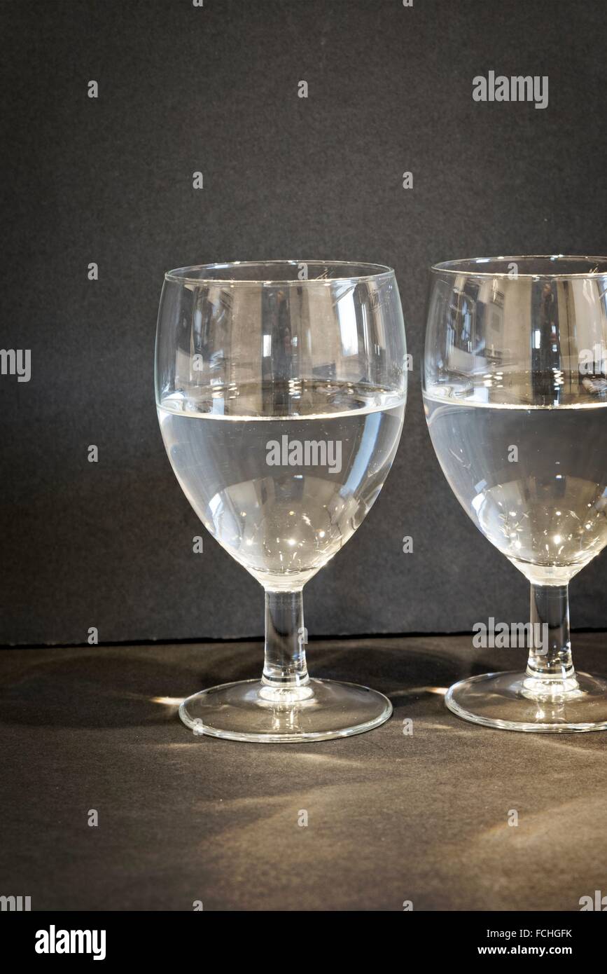 Two Glasses of Water, half full or half empty Stock Photo Alamy