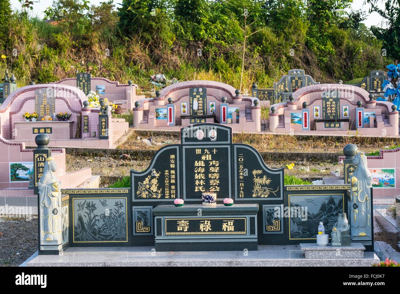 Chinese Grave And Tombstone With Golden Mandarin Writing