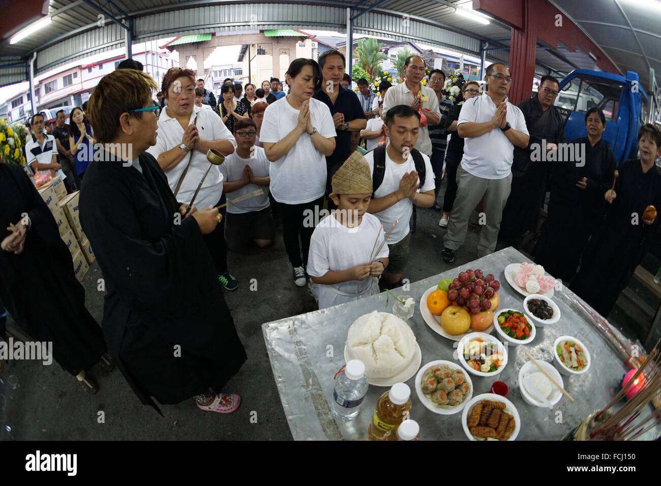 Prayers for the deceased before departing for burial. Sarawakian chinese funeral ceremony