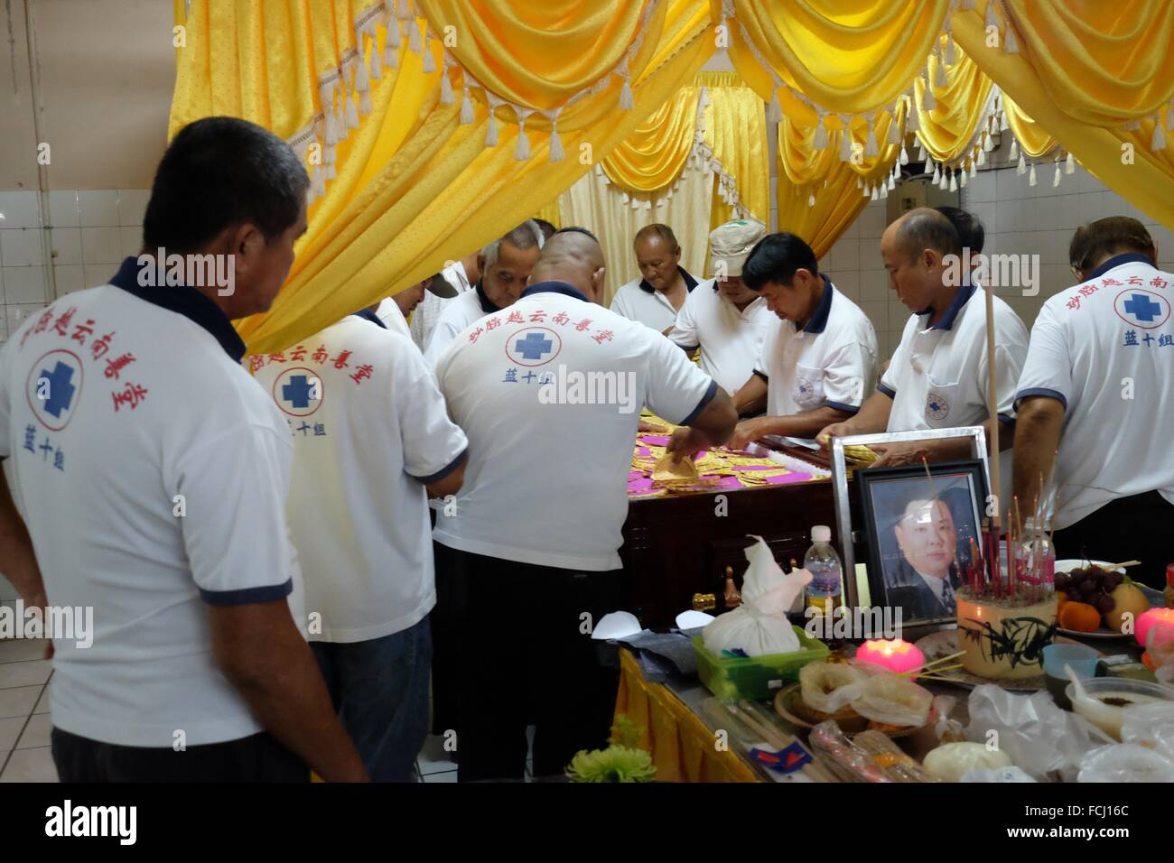 Putting lucky money and flowers to the coffin. Sarawakian chinese funeral ceremony. Malaysia