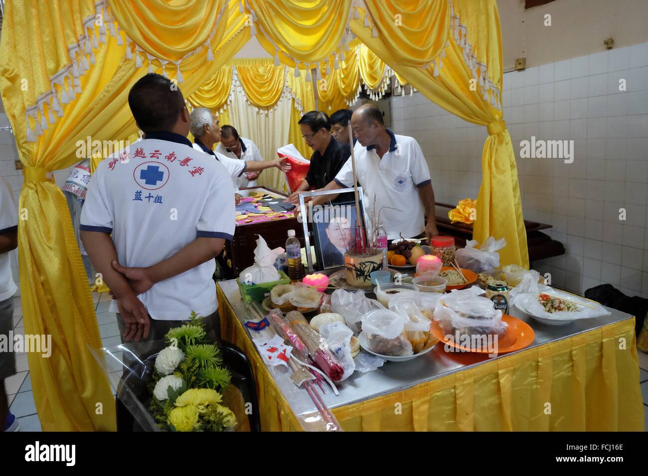Putting lucky money and flowers to the coffin. Sarawakian chinese funeral ceremony. Malaysia