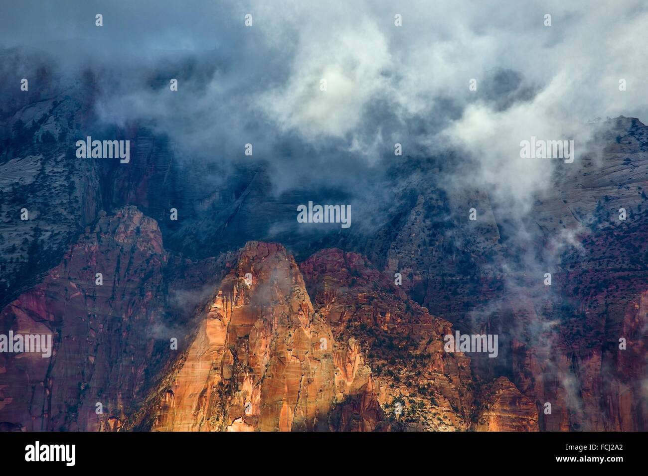 A passing storm deposits fog into Zion Canyon at Zion National Park, Utah. Stock Photo