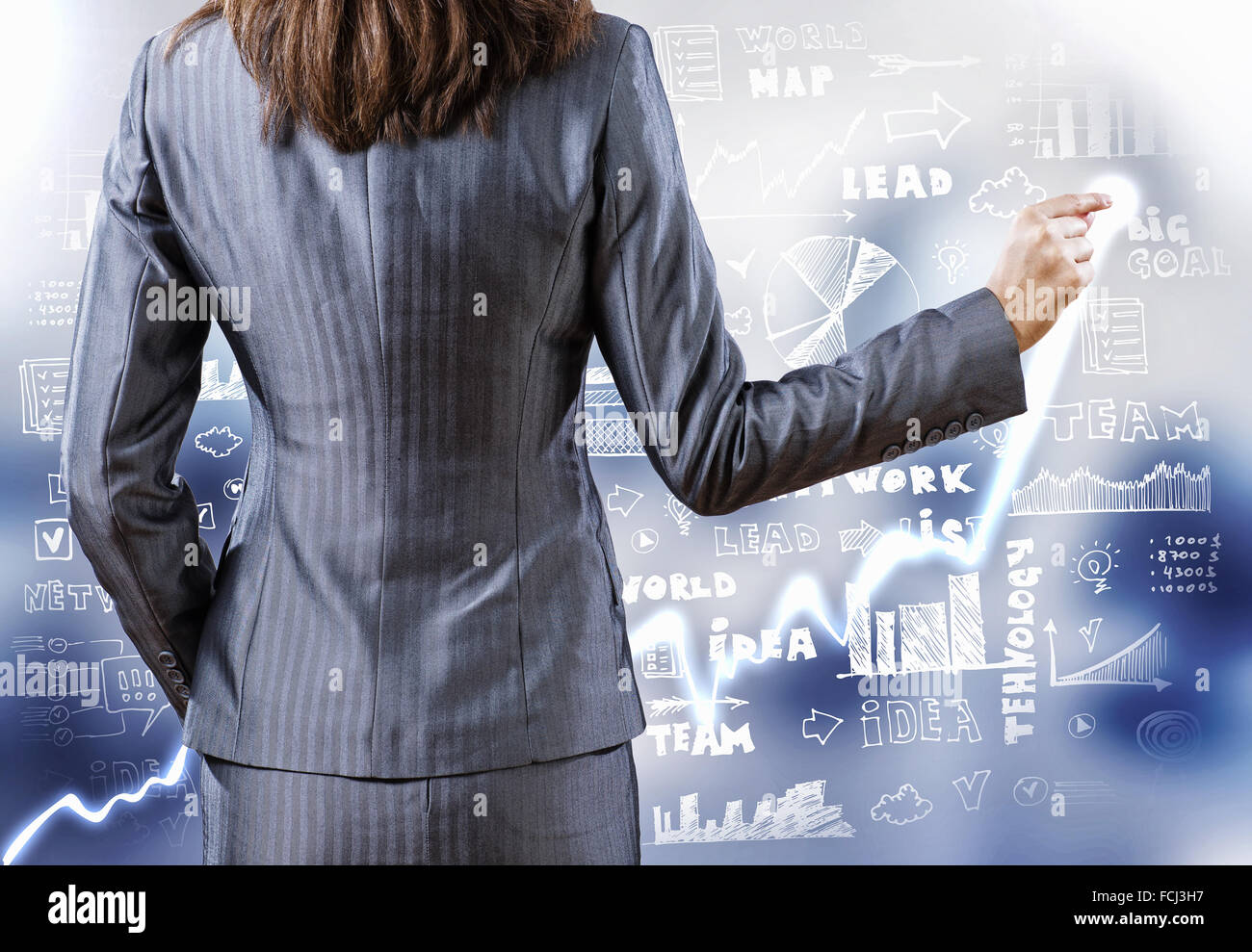 Rear view of businesswoman drawing on digital screen Stock Photo - Alamy