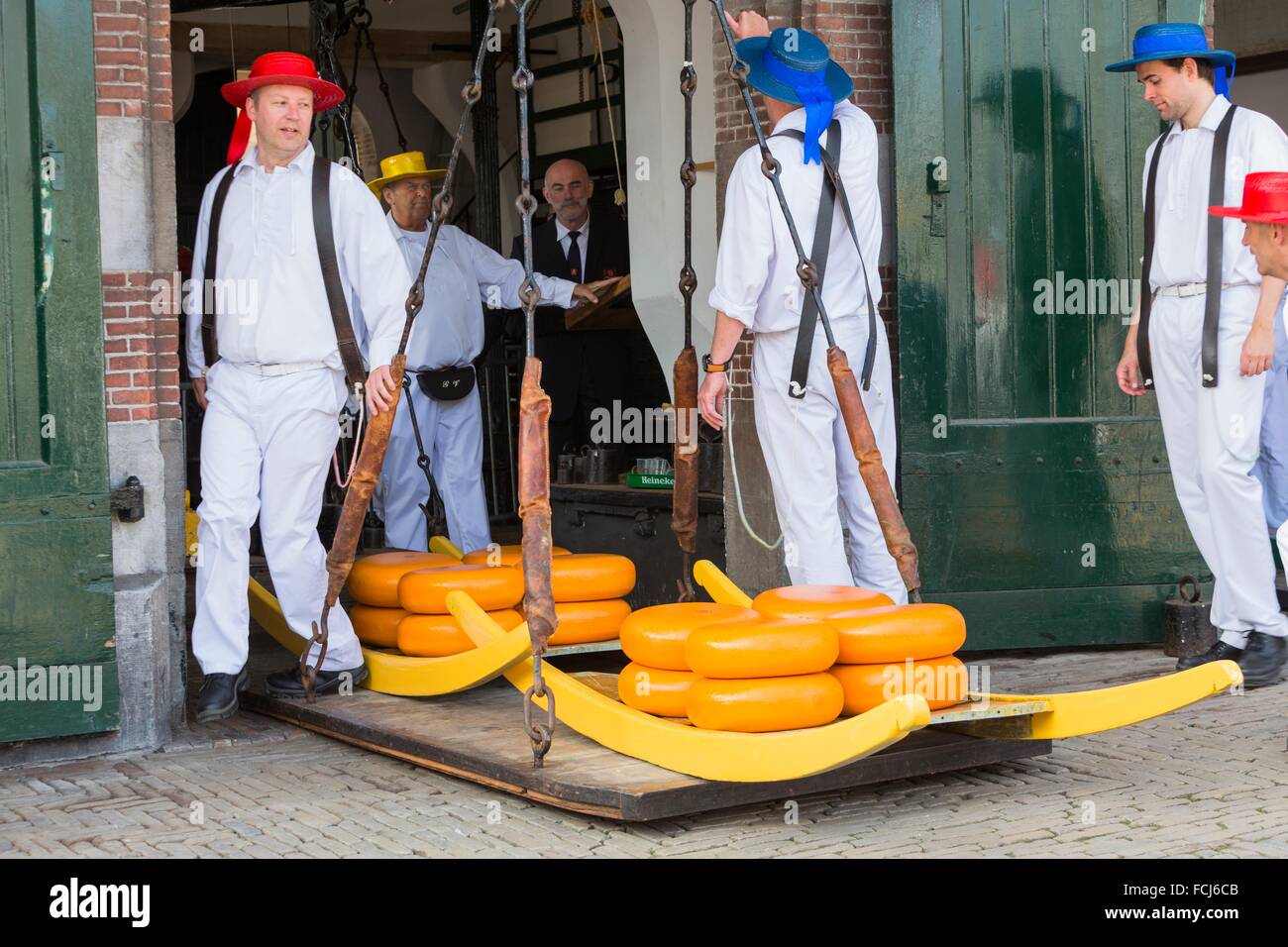 Guild cheeseporters weighing cheeses at the famous cheese market in