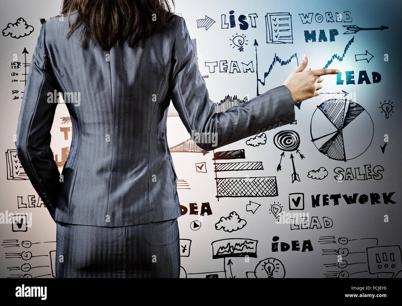 Rear view of businesswoman and sketches at background Stock Photo - Alamy