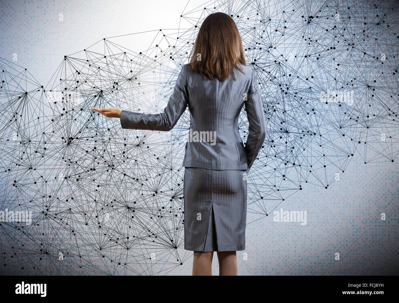 Rear view of businesswoman against digital background Stock Photo - Alamy