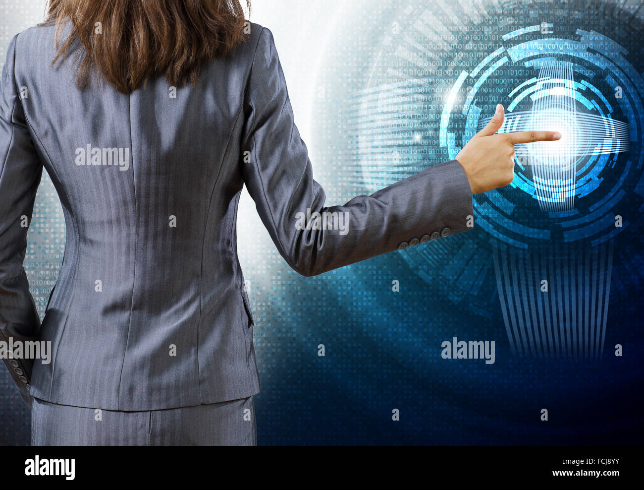 Rear view of businesswoman against digital background Stock Photo - Alamy