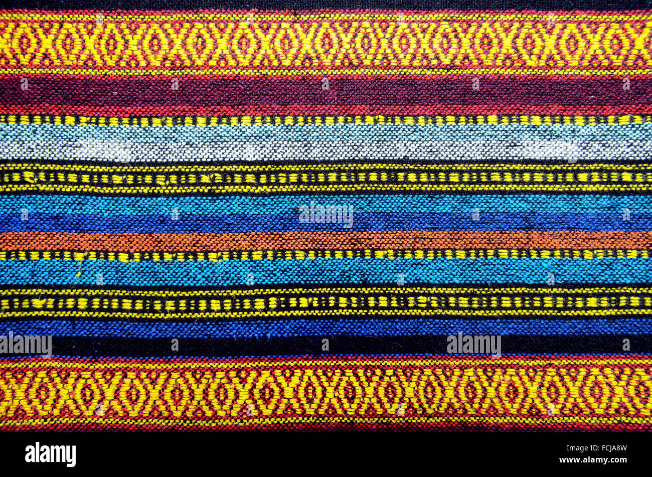 Cross stitch embroidery on canvas.Tribal handmade woven cotton fabrics form Chiengmai, Thailand. Pattern for design element. Stock Photo