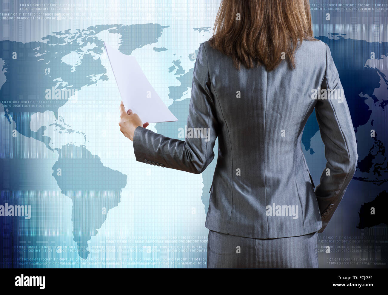 Rear view of businesswoman against digital blue background Stock Photo ...