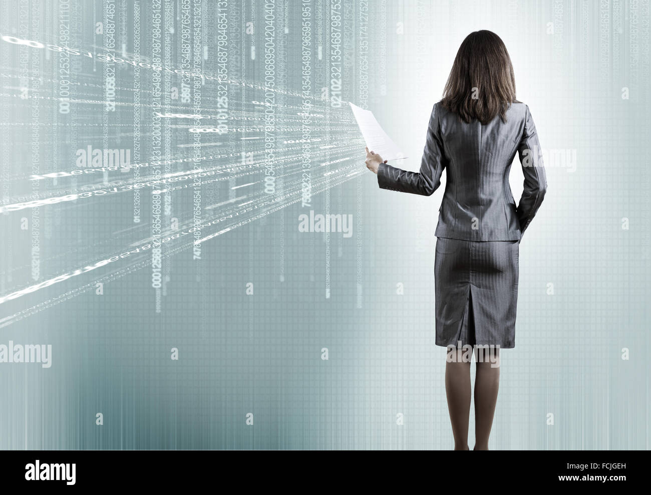 Rear view of businesswoman against binary background Stock Photo - Alamy