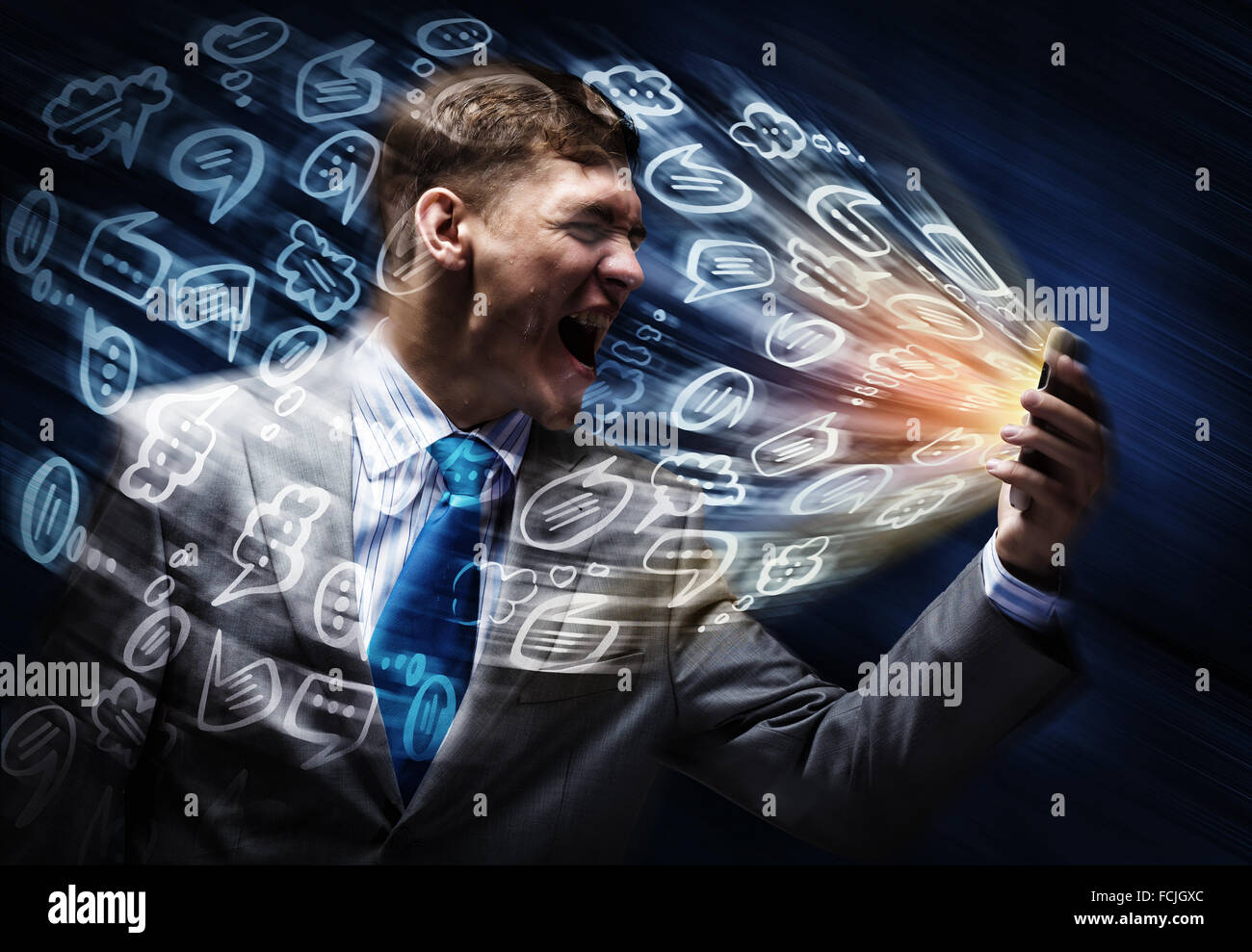 Angry businessman screaming furiously in mobile phone Stock Photo